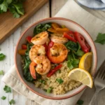 A bowl of spicy shrimp with quinoa and vegetables